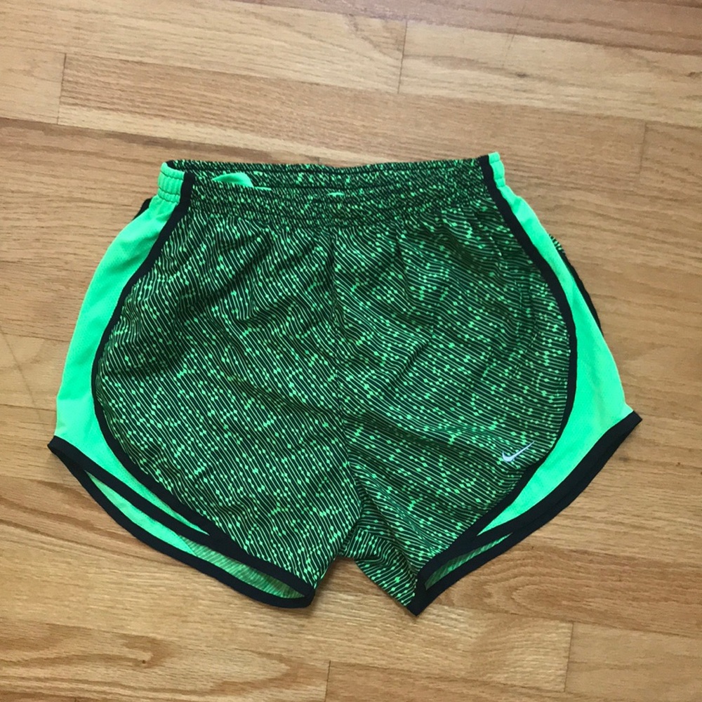 Women’s green and black patterned Nike shorts.